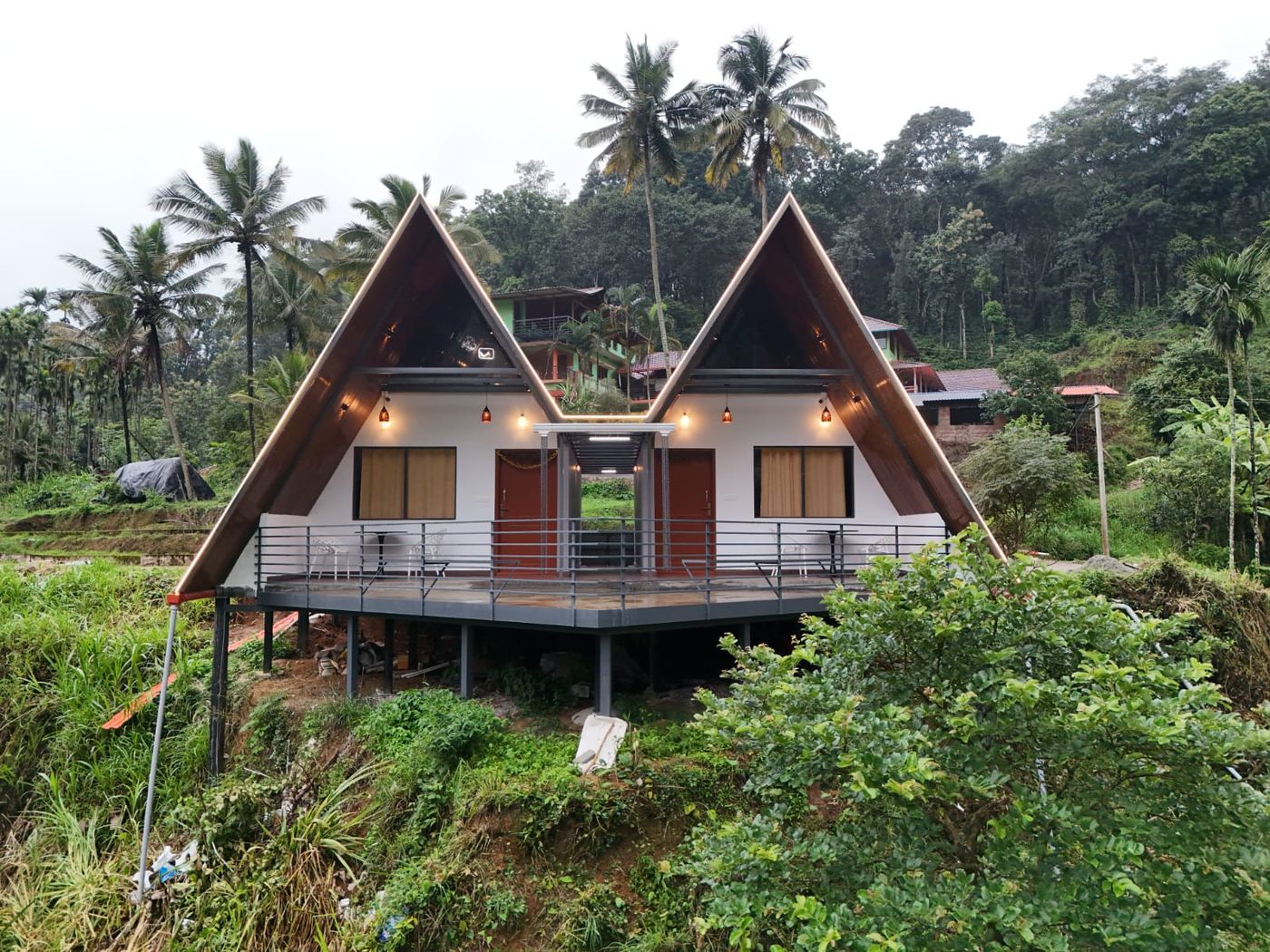 Cottages lit up against the Coorg hillside