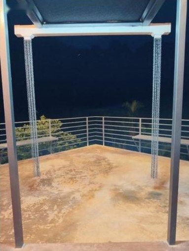 Night view of the balcony with hanging chairs