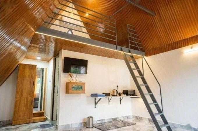 Full room view with TV and loft ladder